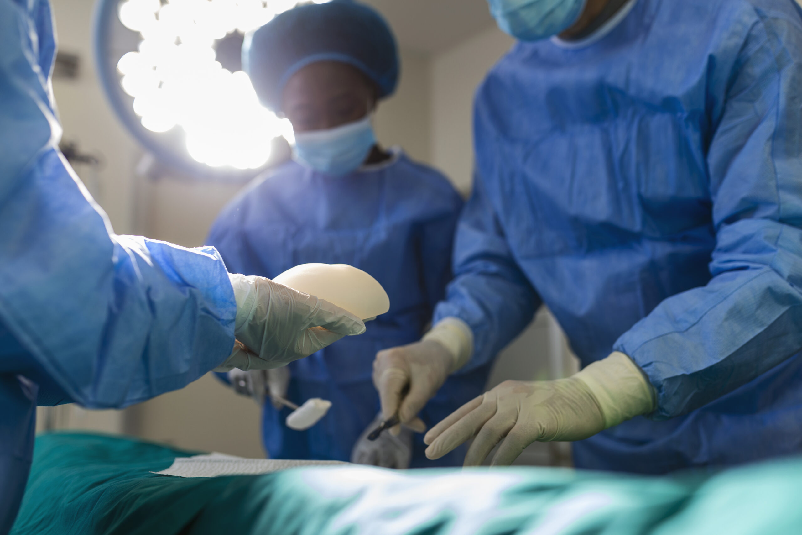 surgeon team in uniform performs an operation on a patient at a cardiac surgery clinic. modern medicine, a professional team of surgeons, health.