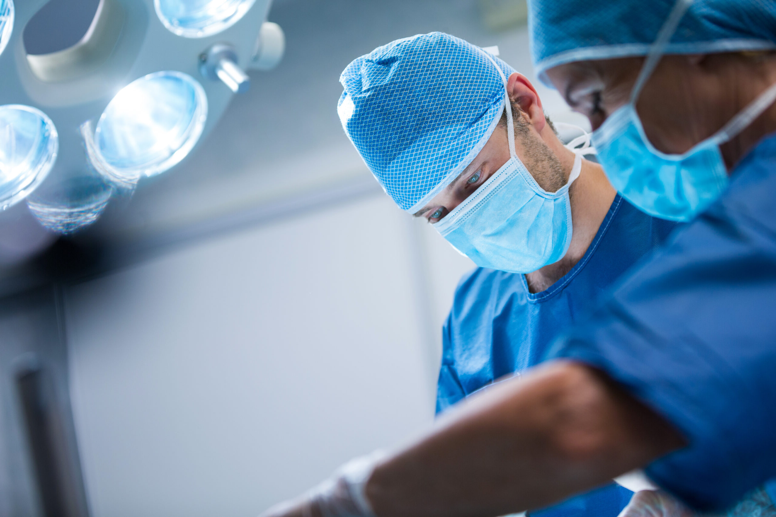 surgeons performing operation in operation room